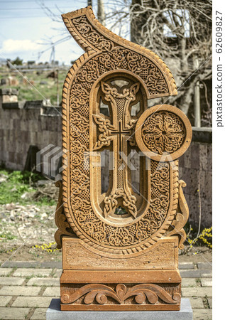 Stone cross carved with ornaments in the form of the twenty-third  letter  of the Armenian alphabet, created by Mesrop Mashtots in the village of Oshakan 62609827