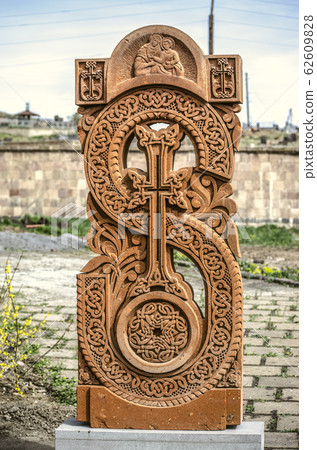 Stone cross carved with ornaments in the form of the thirty-first  letter  of the Armenian alphabet, created by Mesrop Mashtots in the village of Oshakan 62609828