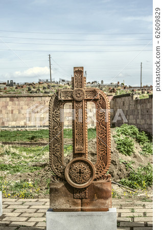 Stone cross carved with ornaments in the form of the thirty-fifth  letter  of the Armenian alphabet, created by Mesrop Mashtots in the village of Oshakan 62609829