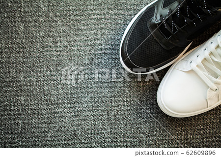 Pair of new stylish sneakers on floor at home. 62609896