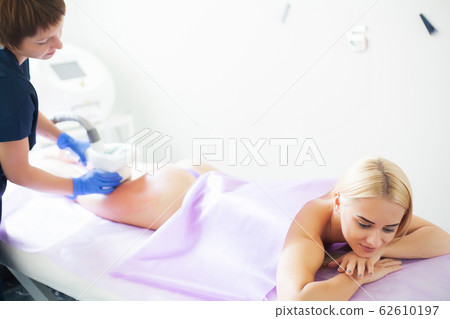 Skin care. Woman is in the process at the clinic lipomassage. Skin care. Woman is in the process at the clinic lipomassage. 62610197