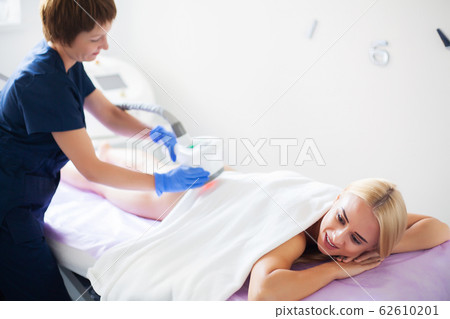 Skin care. Woman is in the process at the clinic lipomassage. Skin care. Woman is in the process at the clinic lipomassage. 62610201
