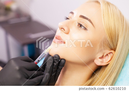 Lip Augmentation In Cosmetology Clinic. Beautiful Woman Getting Beauty Injection For Lips. Lip Augmentation In Cosmetology Clinic. Beautiful Woman Getting Beauty Injection For Lips. 62610210