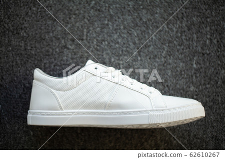 New stylish white sneaker on floor at home. New stylish white sneaker on floor at home. 62610267