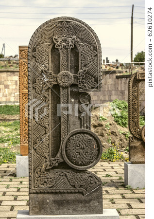 Stone cross carved with ornaments in the form of the eighth letter of the Armenian alphabet, created by Mesrop Mashtots in the village of Oshakan Stone cross carved with ornaments in the form of the eighth letter of the Armenian alphabet, created by Mesrop Mashtots in the village of Oshakan 62610274