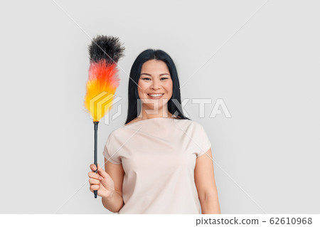 Freestyle. Asian woman standing isolated on white with duster smiling cheerful Freestyle. Asian woman standing isolated on white with duster smiling cheerful 62610968