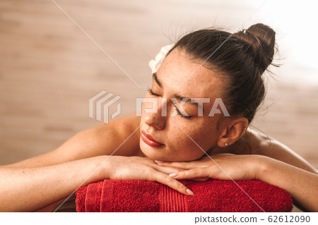 Alternative Medicine. Young woman lying on couch closed eyes smiling relaxed close-up 62612090