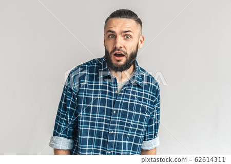 Freestyle. Guy in checkered shirt standing isolated on white looking camera surprised Freestyle. Guy in checkered shirt standing isolated on white looking camera surprised 62614311