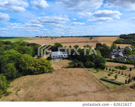 Aerial view of agriculture farmland and and small house during dry summer season 62621627