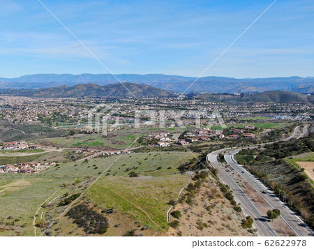 Curving road and downhill with houses in suburb of San Diego 62622978