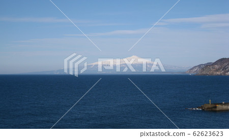 The whole picture of Mt. Chokai with snow scenery floating in the Sea of Japan 62623623