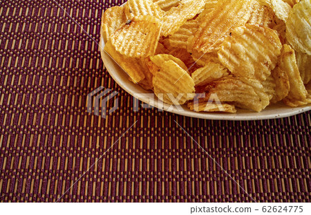 Potato chips on a ceramic plate 12 Potato chips on a ceramic plate 12 62624775
