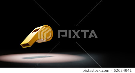 One Yellow Plastic Whistle Spotlighted on Black Background 62624941