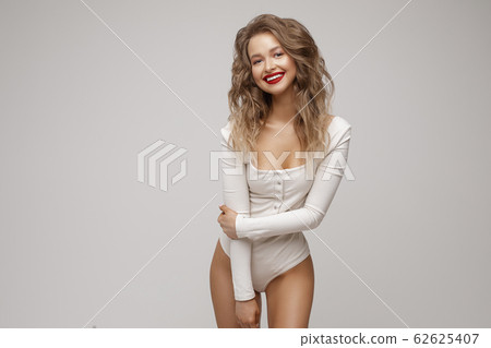 Cheerful beautiful girl with wavy hairstyle in Cheerful beautiful girl with wavy hairstyle in 62625407