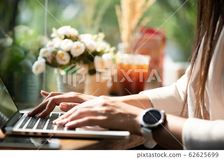 Closeup female hands typing on laptop keyboard. Closeup female hands typing on laptop keyboard. 62625699