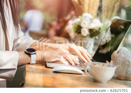 Closeup female hands typing on laptop keyboard. Closeup female hands typing on laptop keyboard. 62625701