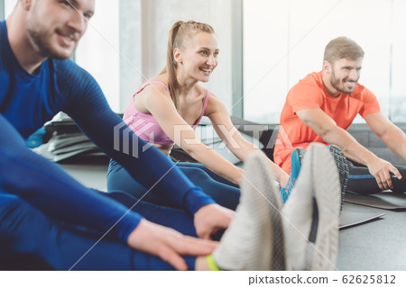 Group in fitness class doing gymnastics and stretching Group in fitness class doing gymnastics and stretching 62625812