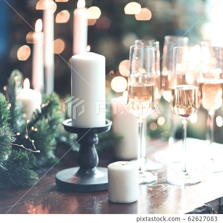 Glasses of sparkling wine on wooden table on 62627083