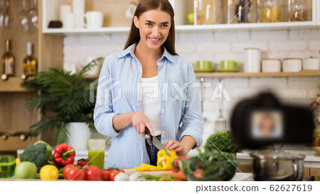 Healthy nutrition blog. Girl cooking vegetable salad 62627619