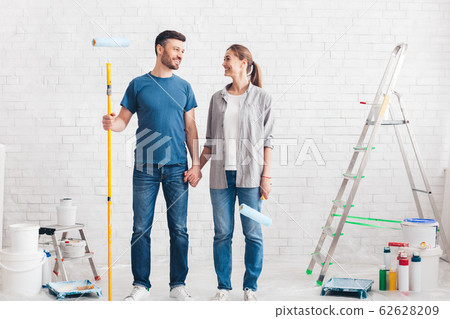Couple with paint and instruments planning home repair 62628209