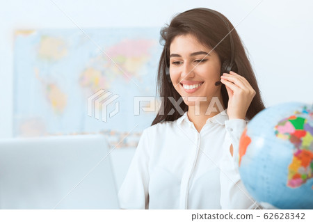 Happy travel agent speaking to customer in office Happy travel agent speaking to customer in office 62628342