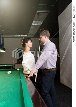 A meeting of lovers in a nightclub by billiards. A meeting of lovers in a nightclub by billiards. 62630443