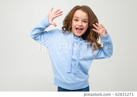 charming teen girl in a blue hoodie shows nine fingers on a light gray background 62631271