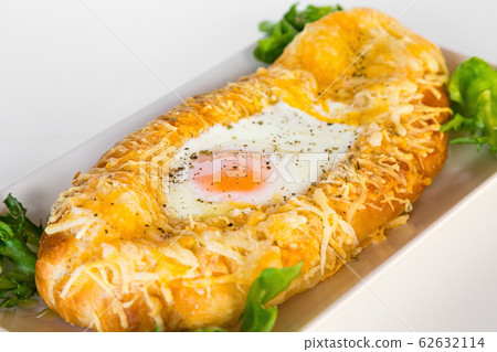 Georgian national pie khachapuri with egg, cheese, butter and salad Georgian national pie khachapuri with egg, cheese, butter and salad 62632114