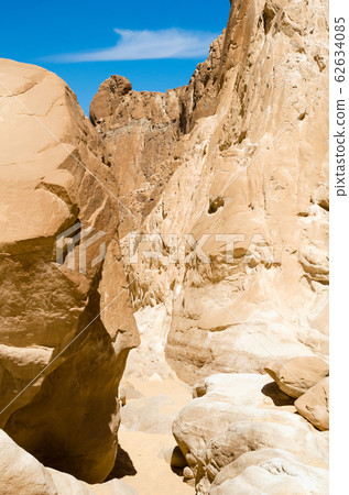 high rocky mountains against the blue sky high rocky mountains against the blue sky 62634085