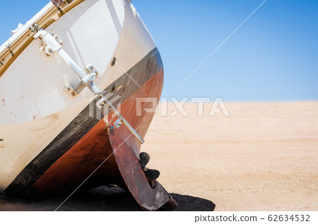 old broken yacht lay on the sand in the desert in Egypt old broken yacht lay on the sand in the desert in Egypt 62634532