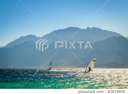 surfers ride in the sea on the background of the rocky coast in Egypt Dahab 62634609