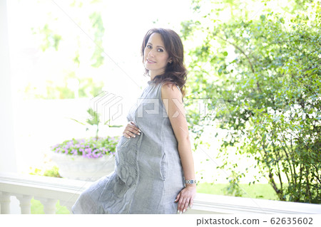 Pregnant woman outdoors 62635602
