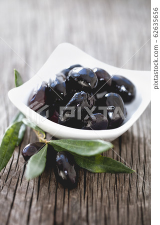 Bowl with black olives on table Bowl with black olives on table 62635656