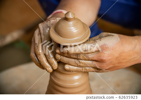 Potter at work makes ceramic dishes. India, Potter at work makes ceramic dishes. India, 62635923