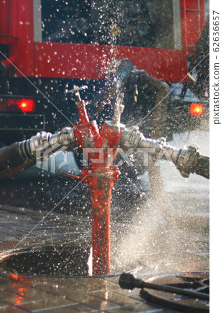 Water splashes from the fire hose and hydrant 62636657