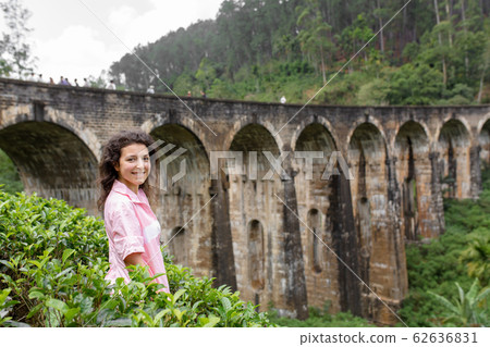 A tourist poses in a tea plantation near the A tourist poses in a tea plantation near the 62636831