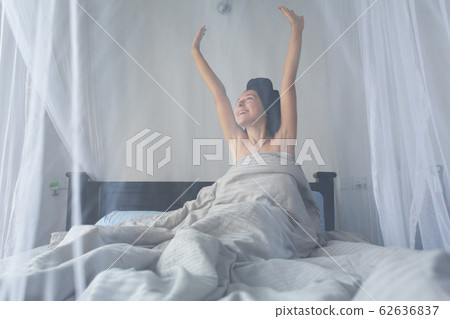 Tender young girl wakes up in the morning Tender young girl wakes up in the morning 62636837