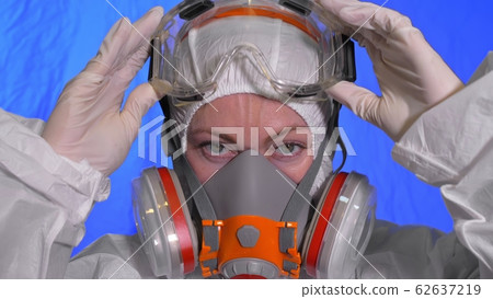Scientist virologist in respirator. Woman close up look, wearing protective medical mask. Concept health safety N1H1 coronavirus epidemic 2019 nCoV. Scientist virologist in respirator. Woman close up look, wearing protective medical mask. Concept health safety N1H1 coronavirus epidemic 2019 nCoV. 62637219