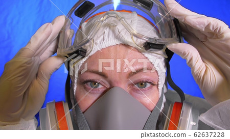 Scientist virologist in respirator. Woman close up look, wearing protective medical mask. Concept health safety N1H1 coronavirus epidemic 2019 nCoV. 62637228