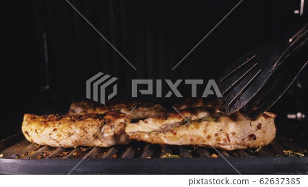Delicious juicy meat steak cooking on the grill. Cook grilling fresh chicken breast. Fry chicken fillet on electric roaster. Slow motion. Delicious juicy meat steak cooking on the grill. Cook grilling fresh chicken breast. Fry chicken fillet on electric roaster. Slow motion. 62637385