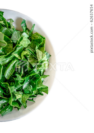 A bunch of young fresh juicy green spinach on a rustic wooden old-time red background. Flat lay 62637654