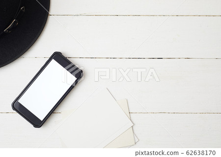 White office desk table with smartphone. White office desk table with smartphone. 62638170
