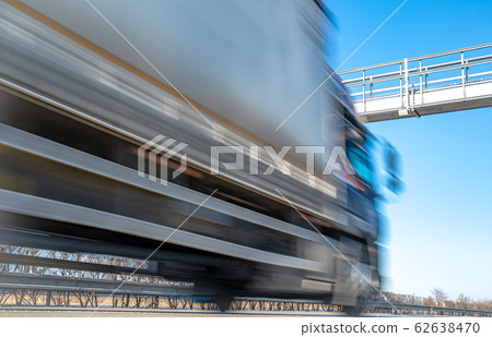 truck drive through the highway through the toll gate, toll charges, blurred motion in the image truck drive through the highway through the toll gate, toll charges, blurred motion in the image 62638470