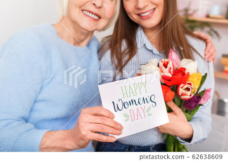 Mom is hugging her daughter and smiling Mom is hugging her daughter and smiling 62638609
