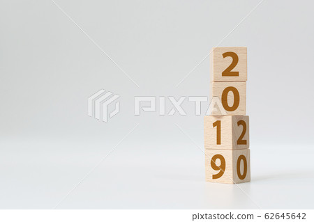 New year 2019 change to 2020 concept. Wooden cube block flip over change years New year 2019 change to 2020 concept. Wooden cube block flip over change years 62645642