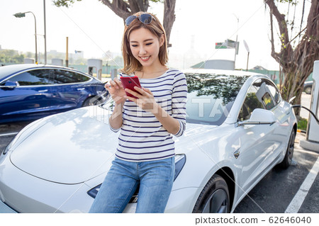 woman Charges electric car 62646040