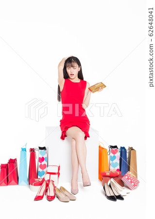 woman sitting with group of shopping bags 62648041