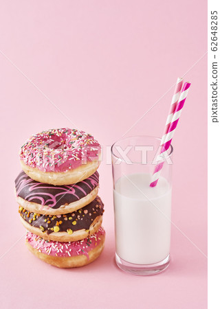 Stack of colorful donuts decorated and glass of Stack of colorful donuts decorated and glass of 62648285
