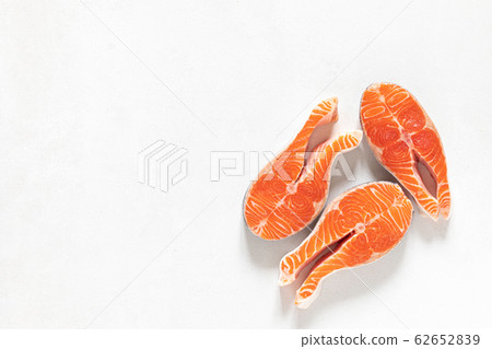 Salmon. Fresh raw salmon fish steaks on white Salmon. Fresh raw salmon fish steaks on white 62652839