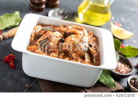 Hake fish, cooked in tomato sauce with vegetables 62652858